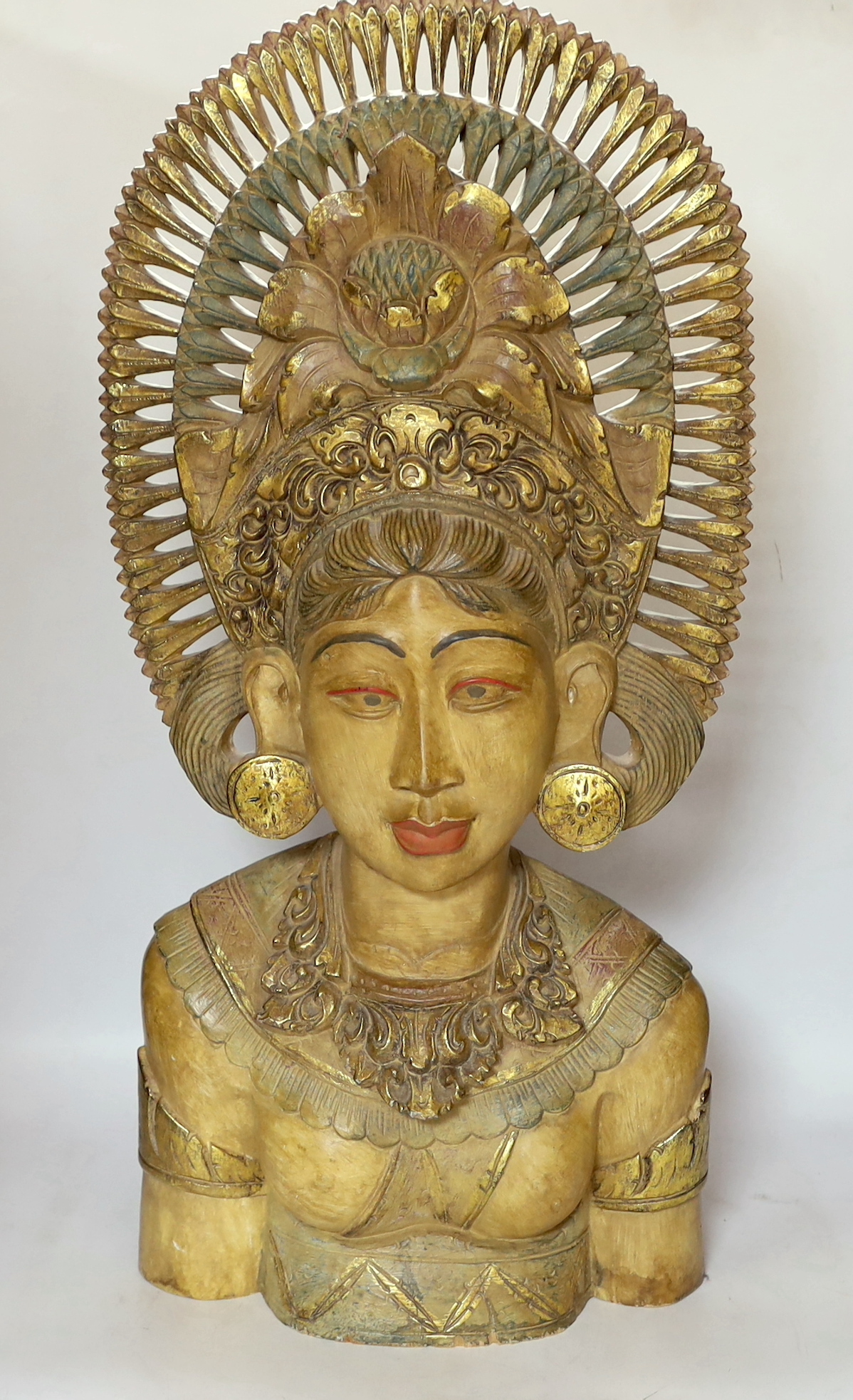 A Balinese carved wood bust of a lady, 69cm